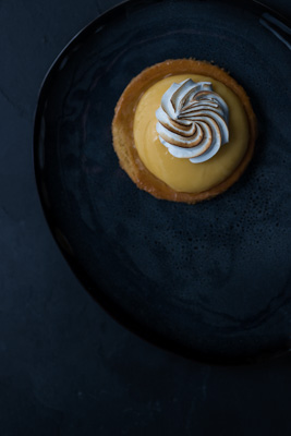 Lemon Pie French tarte au citron on a blakc plate