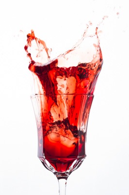 Glass of splash red wine